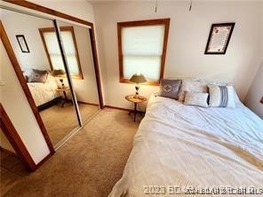 unfurnished bedroom featuring light colored carpet and a closet