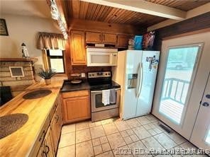 kitchen featuring wood counters, white appliances, wooden ceiling, beamed ceiling, and light tile patterned flooring