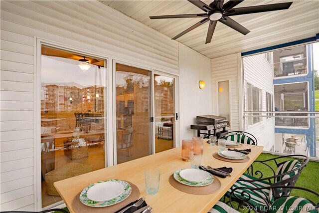 sunroom / solarium featuring ceiling fan and wooden ceiling