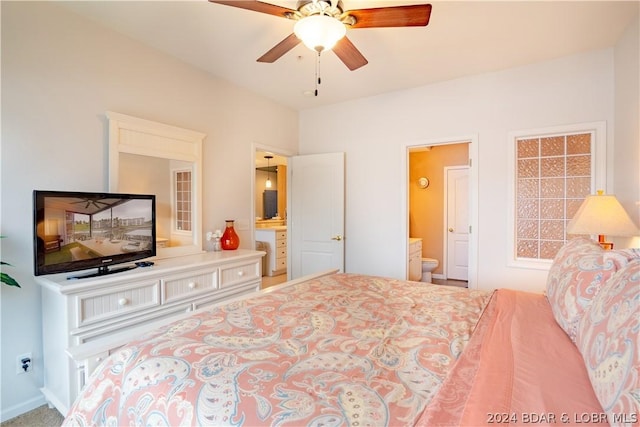 bedroom with ceiling fan and ensuite bath