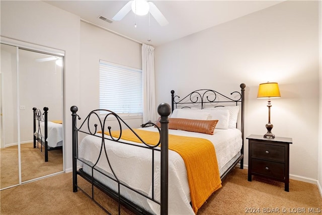 carpeted bedroom featuring ceiling fan and a closet