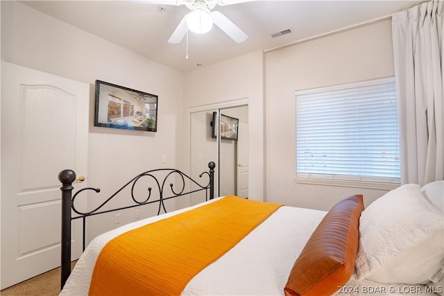 bedroom with ceiling fan, a closet, and carpet