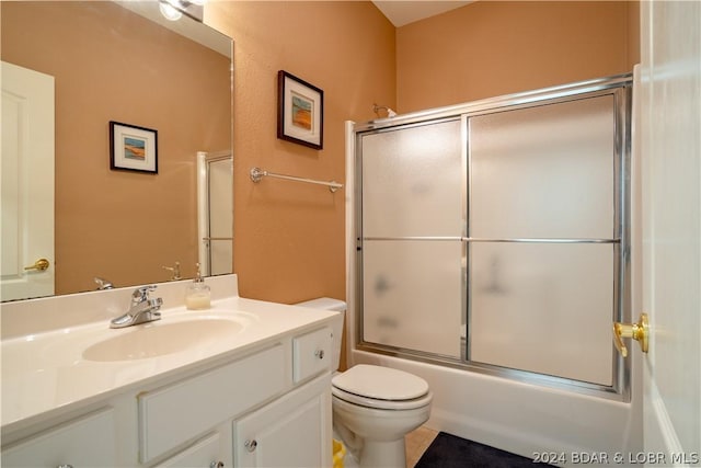 full bathroom with tile patterned floors, vanity, toilet, and enclosed tub / shower combo