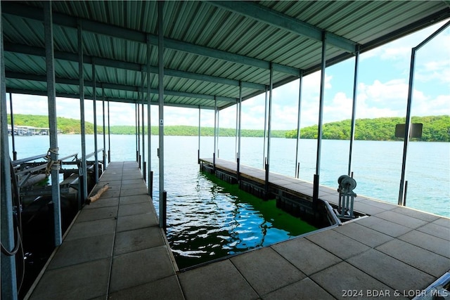 dock area featuring boat lift and a water view