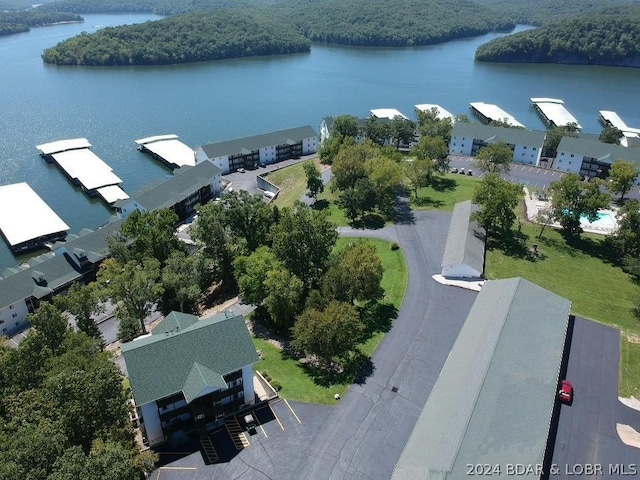 drone / aerial view featuring a view of trees and a water view