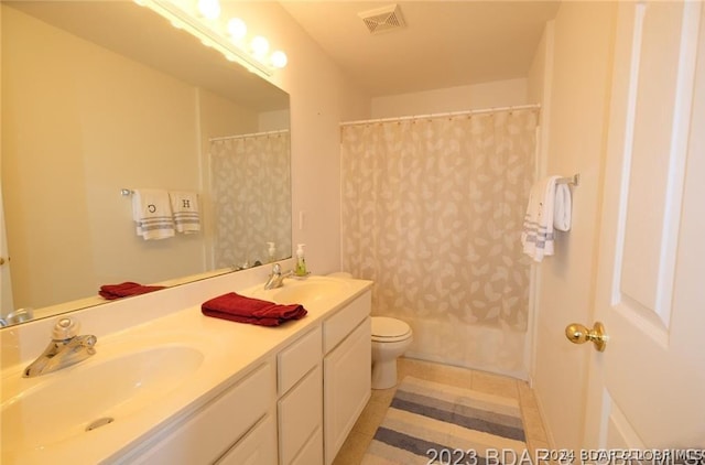 full bath featuring a sink, toilet, double vanity, and visible vents