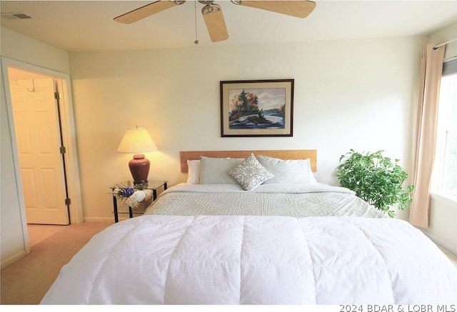 bedroom featuring carpet floors, multiple windows, baseboards, and a ceiling fan
