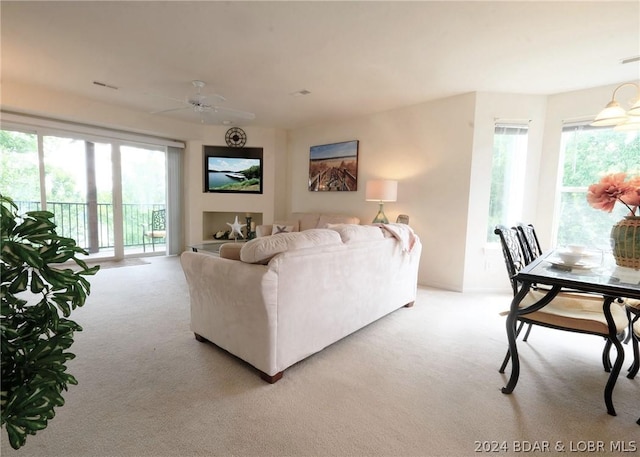 living room featuring light carpet and ceiling fan