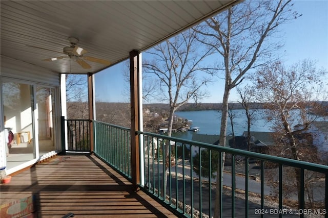 balcony with ceiling fan and a water view