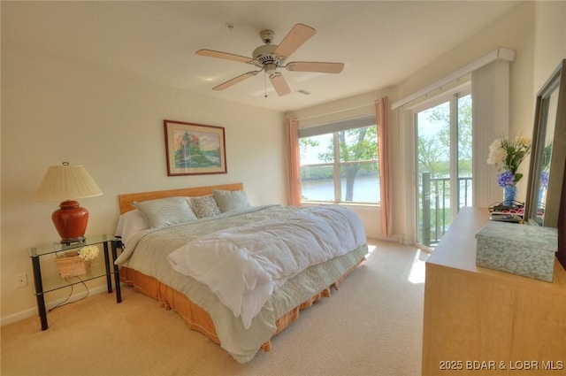 bedroom with access to outside, a ceiling fan, and light colored carpet