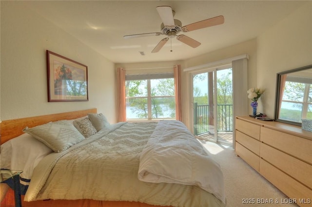 bedroom with access to outside, a ceiling fan, carpet floors, and visible vents