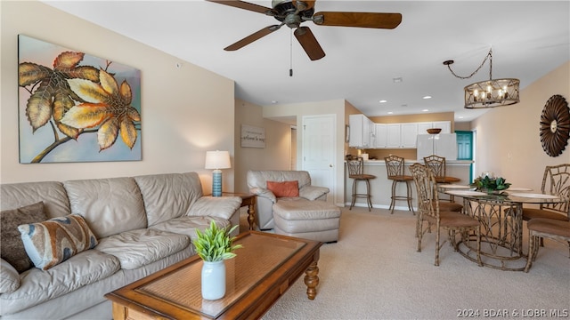 living room with ceiling fan with notable chandelier and light colored carpet