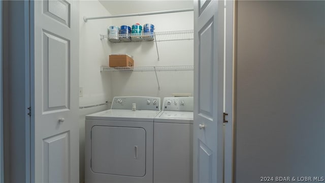 clothes washing area featuring separate washer and dryer