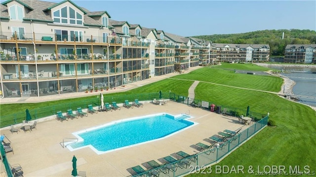 view of swimming pool featuring a yard and a patio