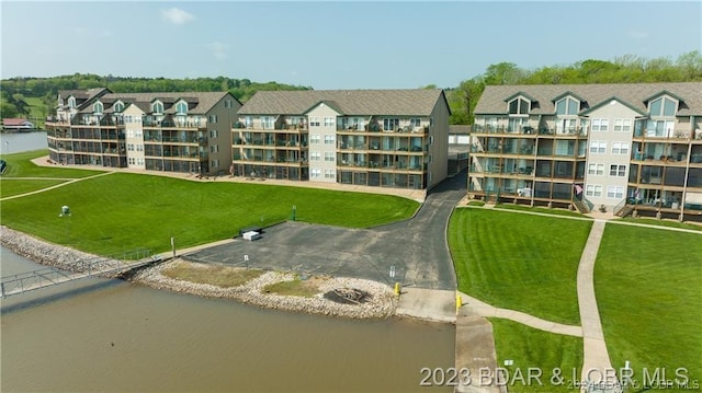 birds eye view of property with a water view