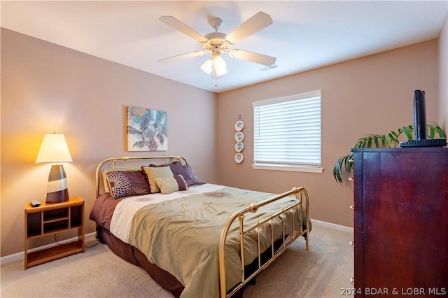 bedroom with ceiling fan and light colored carpet