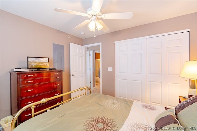 bedroom featuring ceiling fan, electric panel, and a closet