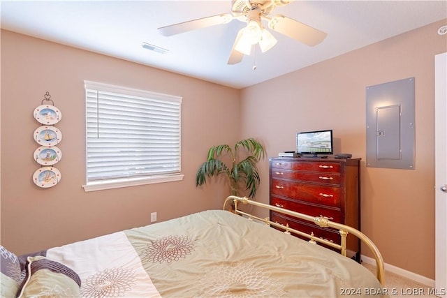 carpeted bedroom featuring ceiling fan and electric panel