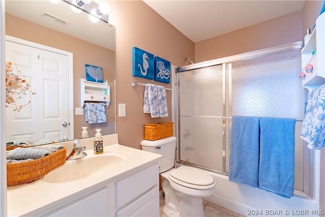 full bathroom with shower / bath combination with glass door, vanity, toilet, and tile patterned flooring