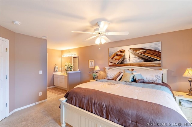 carpeted bedroom featuring ceiling fan and ensuite bathroom