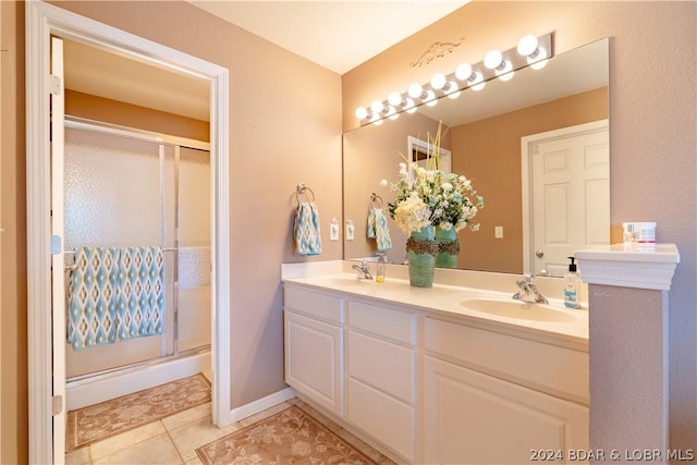 bathroom featuring tile patterned floors, vanity, and walk in shower