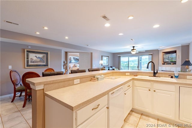 kitchen featuring kitchen peninsula, ceiling fan, sink, light tile patterned floors, and dishwasher