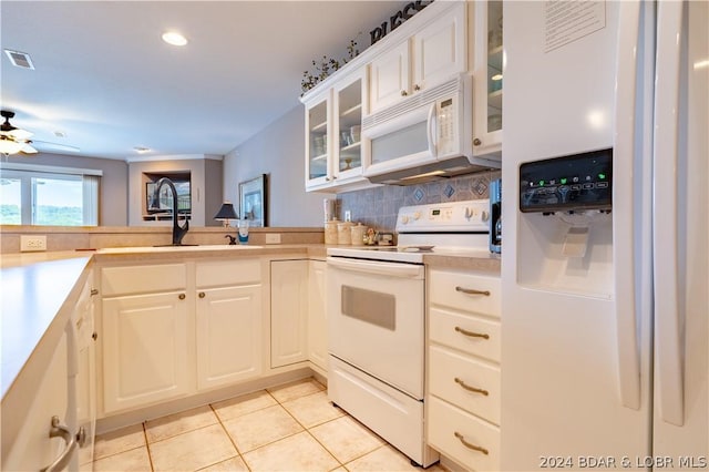 kitchen featuring white cabinets, light tile patterned flooring, white appliances, and backsplash