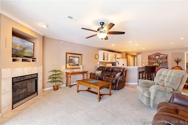 living room featuring a fireplace and ceiling fan