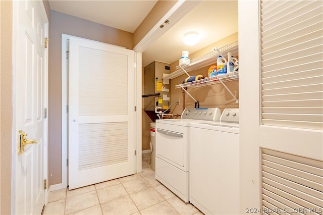 laundry area with light tile patterned floors and separate washer and dryer