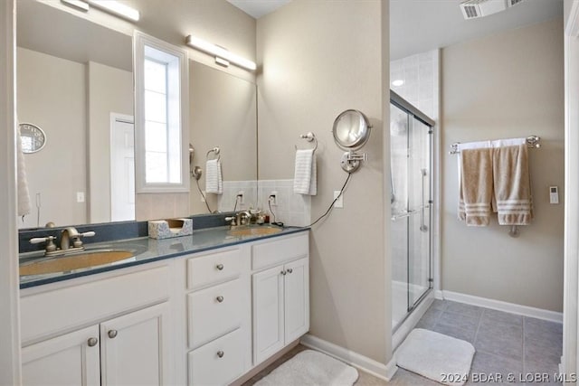 bathroom featuring an enclosed shower, vanity, and plenty of natural light