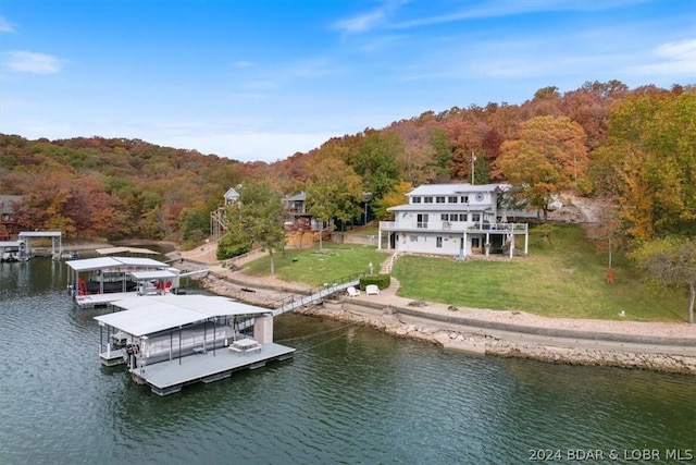 view of dock featuring a yard and a water view