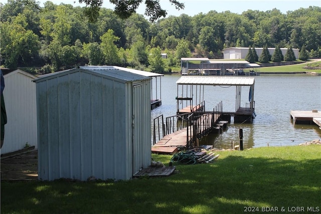 dock area featuring a lawn and a water view