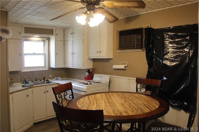 kitchen featuring sink, a wall mounted air conditioner, white cabinets, and electric stove