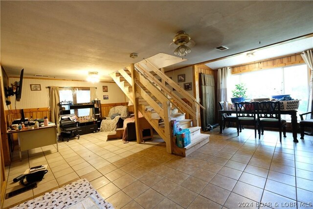 interior space with ceiling fan