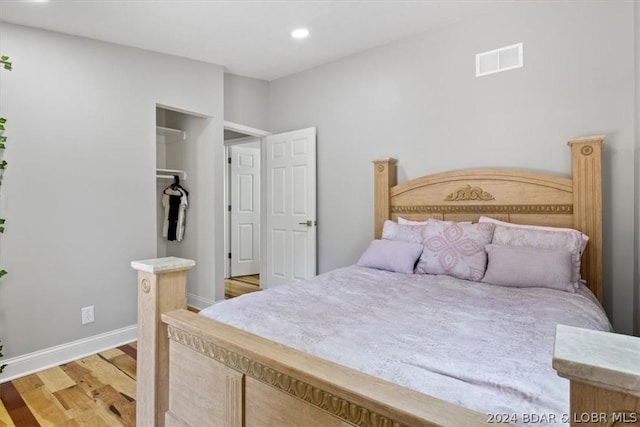 bedroom with hardwood / wood-style floors