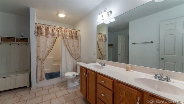 full bathroom with toilet, vanity, tile patterned flooring, and shower / tub combo with curtain