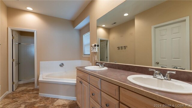 bathroom with vanity and plus walk in shower