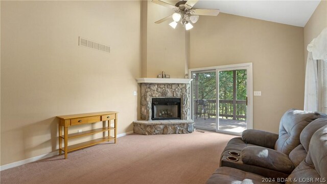 carpeted living room with ceiling fan, high vaulted ceiling, and a fireplace