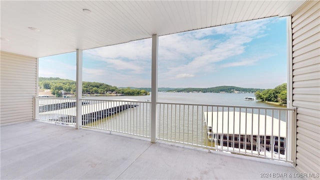 view of patio / terrace with a balcony and a water view