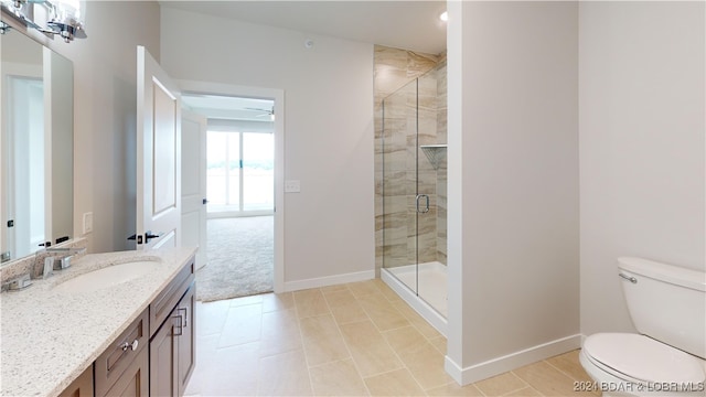 bathroom featuring tile patterned flooring, walk in shower, ceiling fan, vanity, and toilet