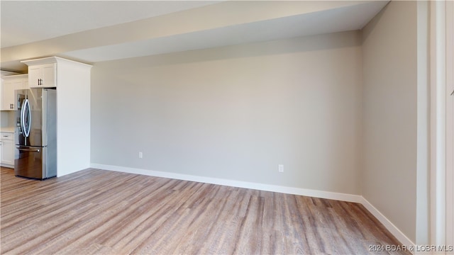 unfurnished room with light wood-type flooring