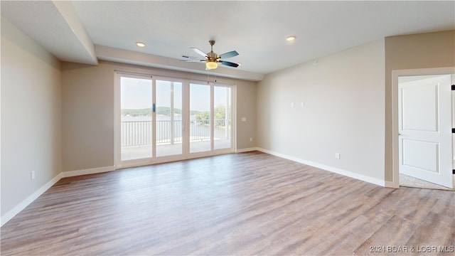 spare room featuring light hardwood / wood-style floors and ceiling fan