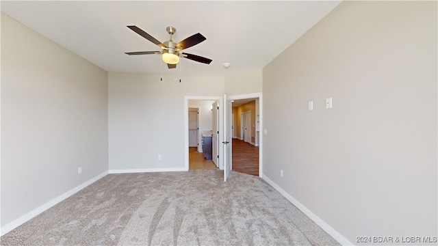 unfurnished bedroom with ceiling fan and light colored carpet