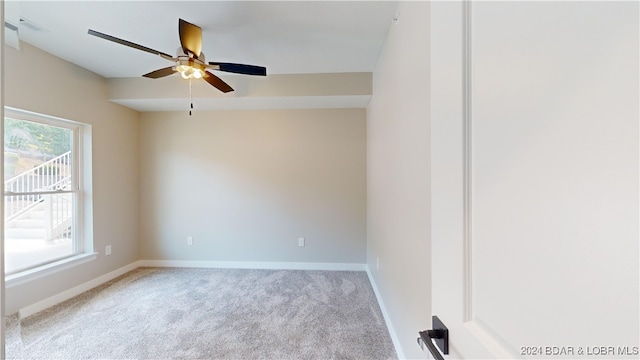 unfurnished room with ceiling fan and light colored carpet