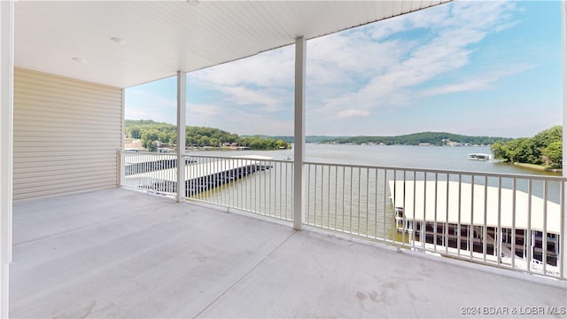 view of patio / terrace featuring a balcony and a water view