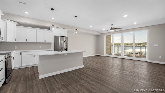 kitchen with pendant lighting, a center island, dark wood-type flooring, white cabinets, and stainless steel appliances