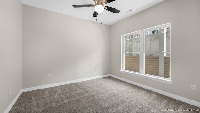 carpeted empty room featuring ceiling fan