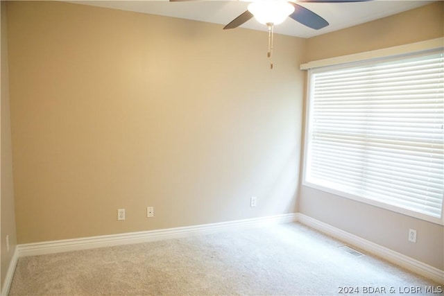 unfurnished room featuring carpet flooring, ceiling fan, and plenty of natural light