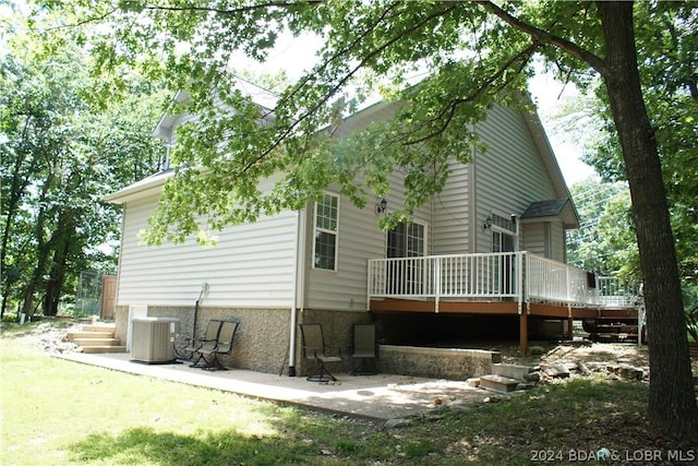 back of house with central AC unit and a patio