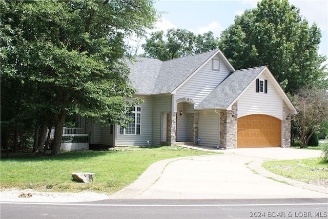 view of front of house featuring a garage and a front lawn